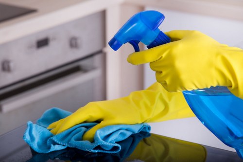 Local cleaner treating a sectional sofa in a Haringey property